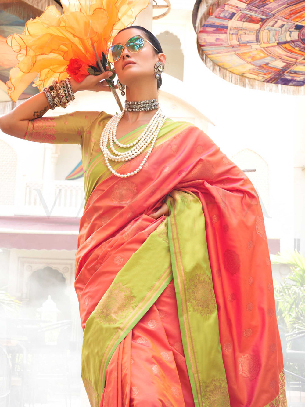Elegant Sunset Coral–Pista Green silk saree with jacquard weave and mandala inspired border detailing. Sunset Coral–Pista Green saree for weddings and sangeet, finished with artistic zari craftsmanship and rich drape.