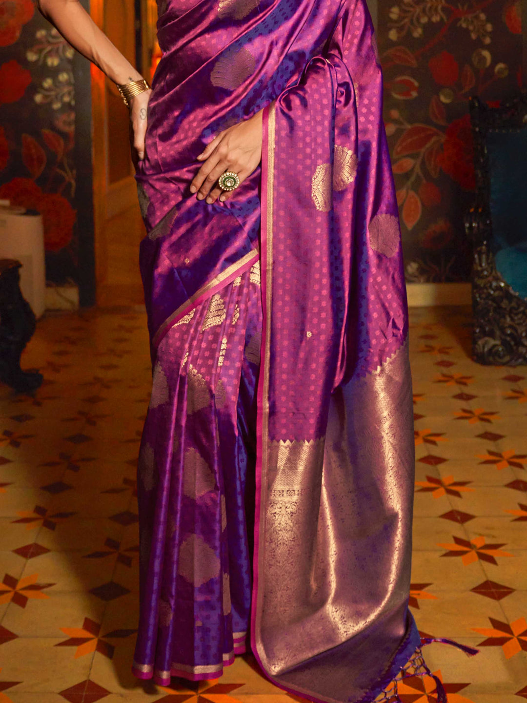 Banarasi satin saree in Rani Pink–Gold styled with heirloom jewelry and festive decor. Ornate pallu with golden motifs set against Rani Pink–Gold satin silk for regal presence..