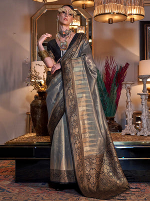 Charcoal Grey–Black tissue silk banarasi saree with bold ikat design woven in rich zari work for elegant events. Luxurious banarasi saree in Charcoal Grey–Black styled with contemporary blouse and statement jewelry..