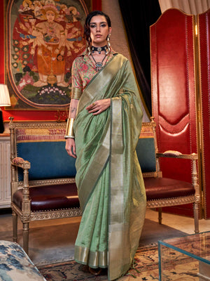 Soft Sage Green chiffon saree with Beige pallu and zari accents This image captures the front drape view highlighting pallu fall and pleats alignment, ideal for visualizing festive elegance, designer appeal, and modern styling inspiration. Perfect for online shoppers seeking detailed previews before purchase, enhancing saree visual merchandising and SEO-rich product display strategy.                                                                                                                              