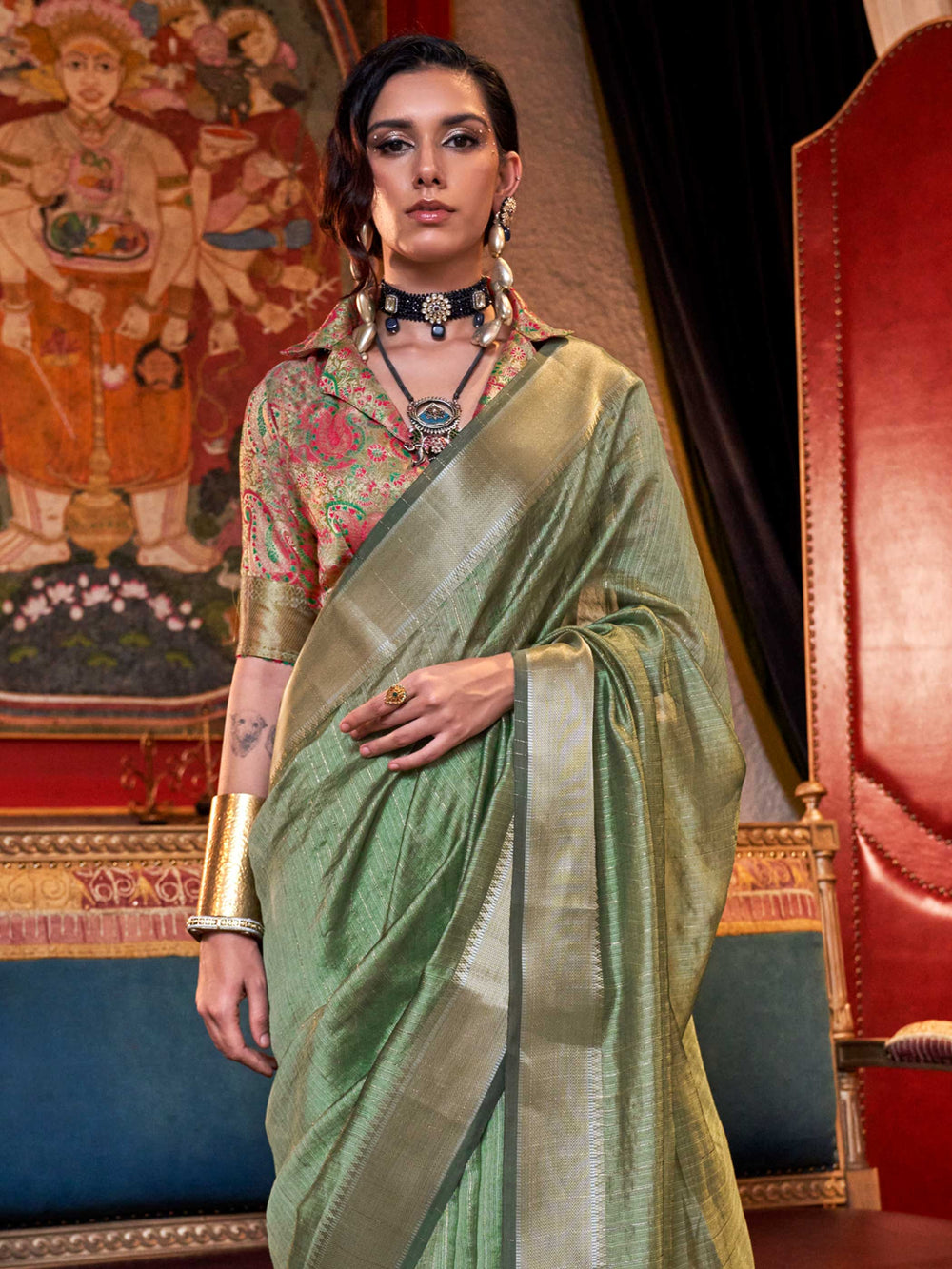 Soft Sage Green chiffon saree with Beige pallu and zari accents This image captures the side angle view showcasing blouse styling and zari border detail, ideal for visualizing festive elegance, designer appeal, and modern styling inspiration. Perfect for online shoppers seeking detailed previews before purchase, enhancing saree visual merchandising and SEO-rich product display strategy.                                                                                                                           