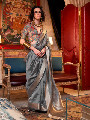 Soft Silver Grey chiffon saree with Platinum pallu and zari accents This image captures the front drape view highlighting pallu fall and pleats alignment, ideal for visualizing festive elegance, designer appeal, and modern styling inspiration. Perfect for online shoppers seeking detailed previews before purchase, enhancing saree visual merchandising and SEO-rich product display strategy.                                                                                                                          