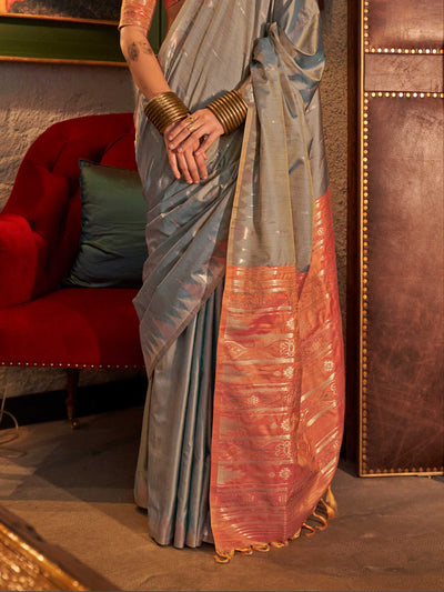 Powder Blue–Copper Peach feathersoft raw silk saree featuring banarasi ikat design, ideal for sangeet night and festive evening wear with rich texture and contrast blouse. Powder Blue–Copper Peach feathersoft raw silk saree featuring banarasi ikat design, ideal for sangeet night and festive evening wear with rich texture and contrast blouse..