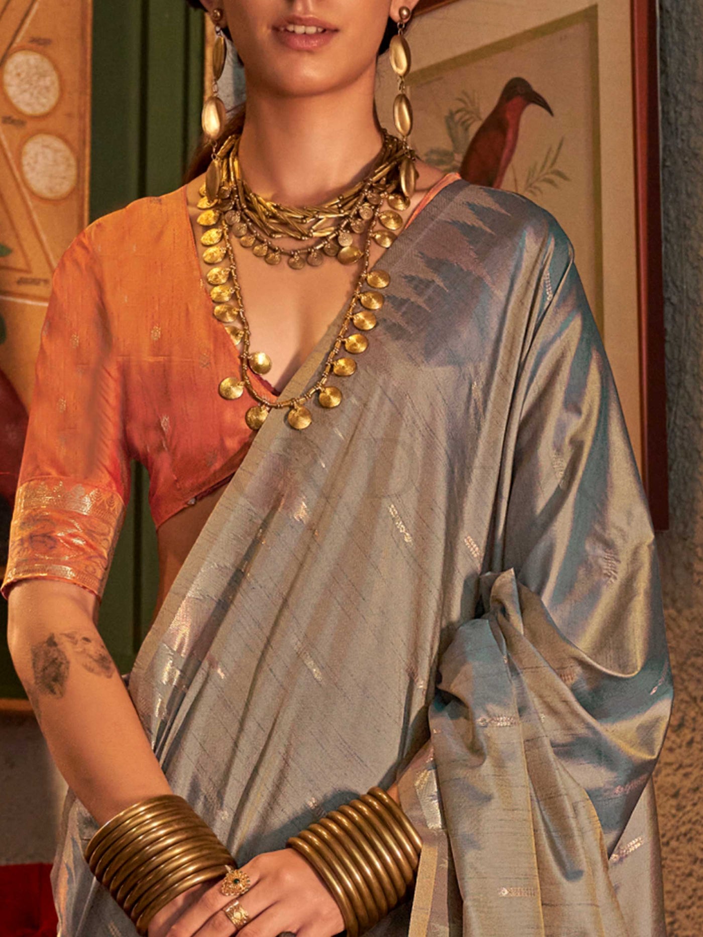 Powder Blue–Copper Peach feathersoft raw silk saree featuring banarasi ikat design, ideal for sangeet night and festive evening wear with rich texture and contrast blouse. Powder Blue–Copper Peach feathersoft raw silk saree featuring banarasi ikat design, ideal for sangeet night and festive evening wear with rich texture and contrast blouse..
