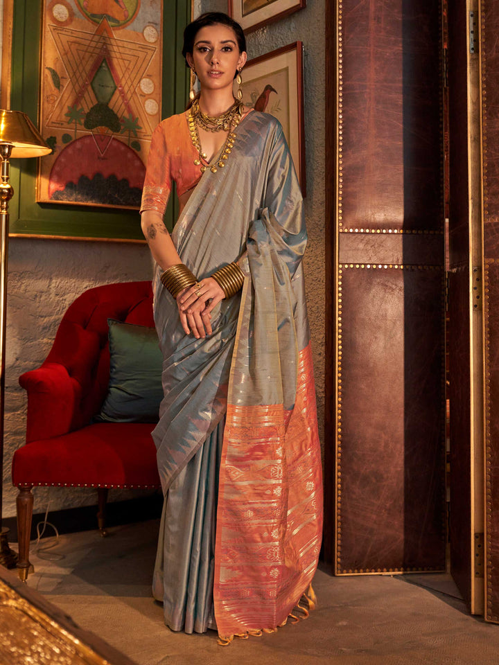Powder Blue–Copper Peach feathersoft raw silk saree featuring banarasi ikat design, ideal for sangeet night and festive evening wear with rich texture and contrast blouse. Powder Blue–Copper Peach feathersoft raw silk saree featuring banarasi ikat design, ideal for sangeet night and festive evening wear with rich texture and contrast blouse..