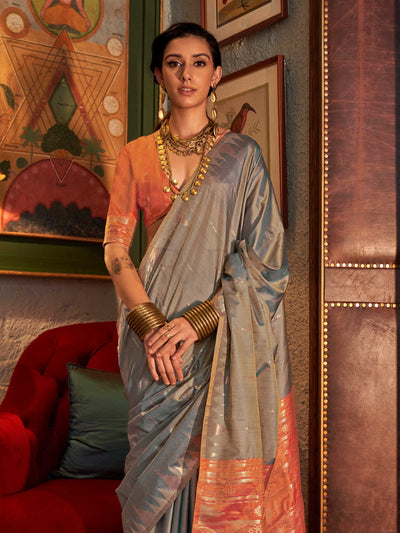 Powder Blue–Copper Peach feathersoft raw silk saree featuring banarasi ikat design, ideal for sangeet night and festive evening wear with rich texture and contrast blouse. Powder Blue–Copper Peach feathersoft raw silk saree featuring banarasi ikat design, ideal for sangeet night and festive evening wear with rich texture and contrast blouse..