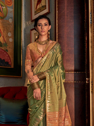 Olive Green–Dusky Rose feathersoft raw silk saree featuring banarasi ikat design, ideal for sangeet night and festive evening wear with rich texture and contrast blouse. Olive Green–Dusky Rose feathersoft raw silk saree featuring banarasi ikat design, ideal for sangeet night and festive evening wear with rich texture and contrast blouse..