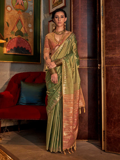 Olive Green–Dusky Rose feathersoft raw silk saree featuring banarasi ikat design, ideal for sangeet night and festive evening wear with rich texture and contrast blouse. Olive Green–Dusky Rose feathersoft raw silk saree featuring banarasi ikat design, ideal for sangeet night and festive evening wear with rich texture and contrast blouse..
