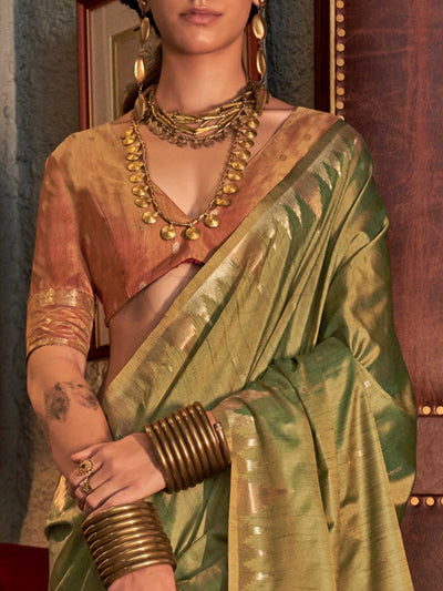 Olive Green–Dusky Rose feathersoft raw silk saree featuring banarasi ikat design, ideal for sangeet night and festive evening wear with rich texture and contrast blouse. Olive Green–Dusky Rose feathersoft raw silk saree featuring banarasi ikat design, ideal for sangeet night and festive evening wear with rich texture and contrast blouse..
