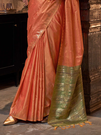 Peach Orange–Leaf Green feathersoft raw silk saree featuring banarasi ikat design, ideal for sangeet night and festive evening wear with rich texture and contrast blouse. Peach Orange–Leaf Green feathersoft raw silk saree featuring banarasi ikat design, ideal for sangeet night and festive evening wear with rich texture and contrast blouse..