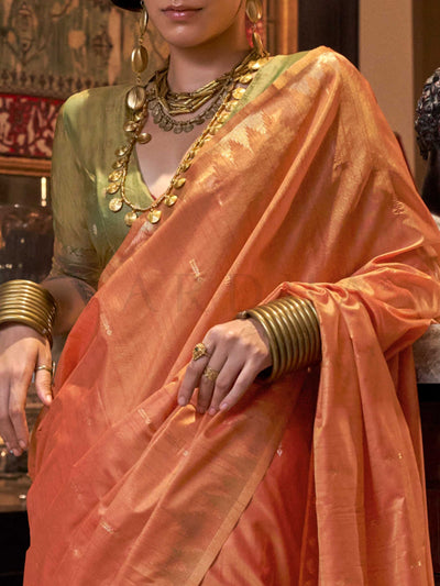 Peach Orange–Leaf Green feathersoft raw silk saree featuring banarasi ikat design, ideal for sangeet night and festive evening wear with rich texture and contrast blouse. Peach Orange–Leaf Green feathersoft raw silk saree featuring banarasi ikat design, ideal for sangeet night and festive evening wear with rich texture and contrast blouse..