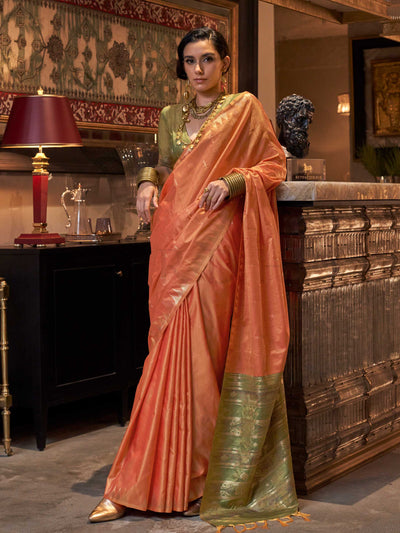 Peach Orange–Leaf Green feathersoft raw silk saree featuring banarasi ikat design, ideal for sangeet night and festive evening wear with rich texture and contrast blouse. Peach Orange–Leaf Green feathersoft raw silk saree featuring banarasi ikat design, ideal for sangeet night and festive evening wear with rich texture and contrast blouse..