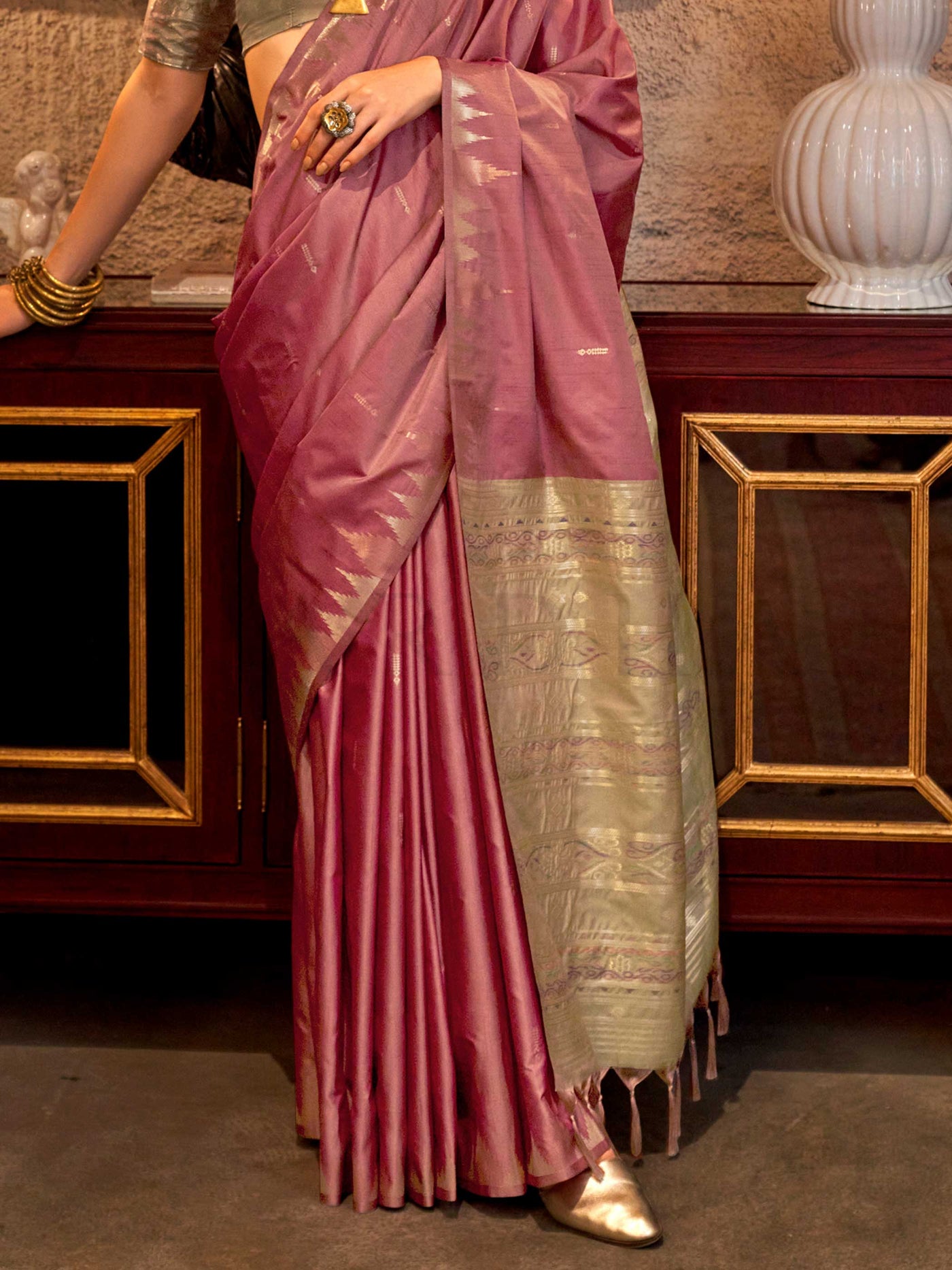 Dusty Rose–Pale Gold feathersoft raw silk saree featuring banarasi ikat design, ideal for sangeet night and festive evening wear with rich texture and contrast blouse. Dusty Rose–Pale Gold feathersoft raw silk saree featuring banarasi ikat design, ideal for sangeet night and festive evening wear with rich texture and contrast blouse..