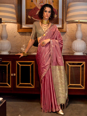 Dusty Rose–Pale Gold feathersoft raw silk saree featuring banarasi ikat design, ideal for sangeet night and festive evening wear with rich texture and contrast blouse. Dusty Rose–Pale Gold feathersoft raw silk saree featuring banarasi ikat design, ideal for sangeet night and festive evening wear with rich texture and contrast blouse..