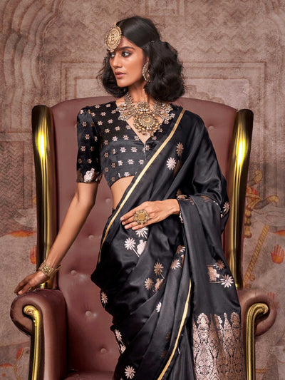 Black–Rose Gold satin silk saree with jacquard woven motifs and floral zari detailing. Perfect partywear or reception look with embroidered blouse and traditional drape, ideal for festive fashion styling. Black–Rose Gold satin silk saree with jacquard woven motifs and floral zari detailing. Perfect partywear or reception look with embroidered blouse and traditional drape, ideal for festive fashion styling..