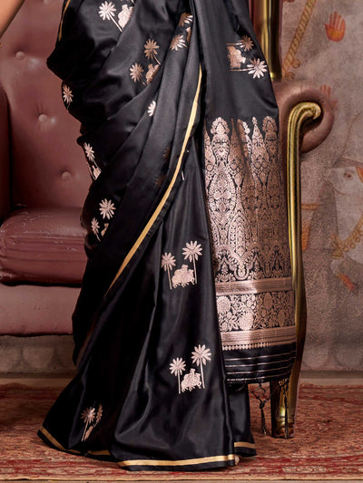 Black–Rose Gold satin silk saree with jacquard woven motifs and floral zari detailing. Perfect partywear or reception look with embroidered blouse and traditional drape, ideal for festive fashion styling. Black–Rose Gold satin silk saree with jacquard woven motifs and floral zari detailing. Perfect partywear or reception look with embroidered blouse and traditional drape, ideal for festive fashion styling..