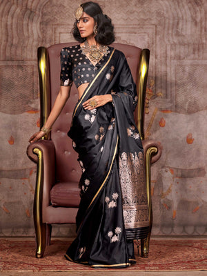 Black–Rose Gold satin silk saree with jacquard woven motifs and floral zari detailing. Perfect partywear or reception look with embroidered blouse and traditional drape, ideal for festive fashion styling. Black–Rose Gold satin silk saree with jacquard woven motifs and floral zari detailing. Perfect partywear or reception look with embroidered blouse and traditional drape, ideal for festive fashion styling..