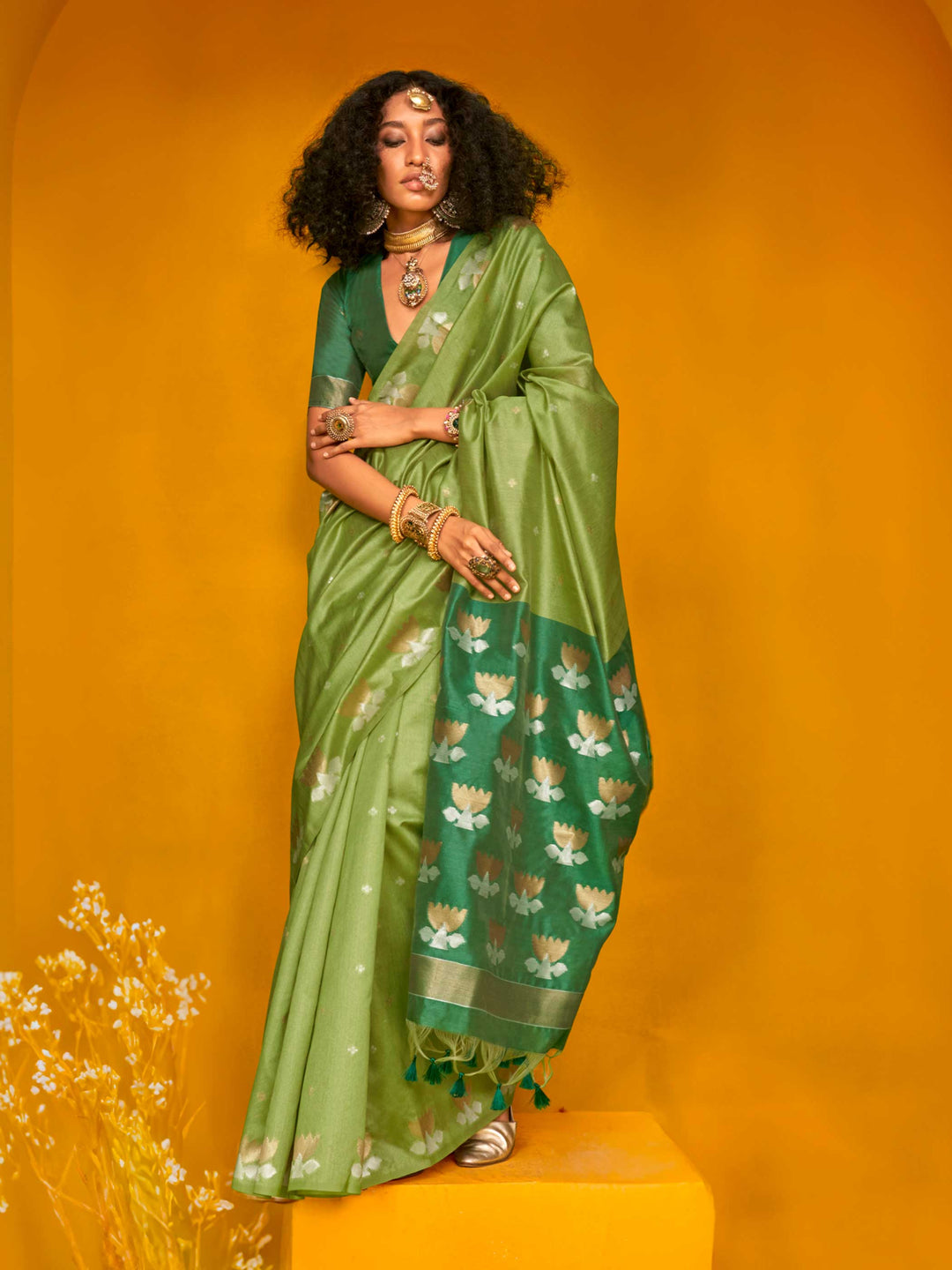 Leaf Green–Teal Green feathersoft tussar silk saree featuring woven lotus motifs and soft pallu, styled for festive rituals with a breathable finish. Leaf Green–Teal Green feathersoft tussar silk saree featuring woven lotus motifs and soft pallu, styled for festive rituals with a breathable finish..