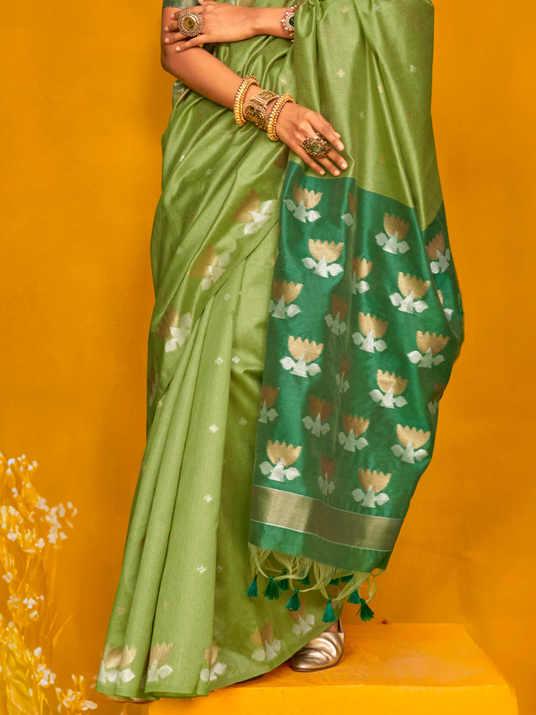 Leaf Green–Teal Green feathersoft tussar silk saree featuring woven lotus motifs and soft pallu, styled for festive rituals with a breathable finish. Leaf Green–Teal Green feathersoft tussar silk saree featuring woven lotus motifs and soft pallu, styled for festive rituals with a breathable finish..