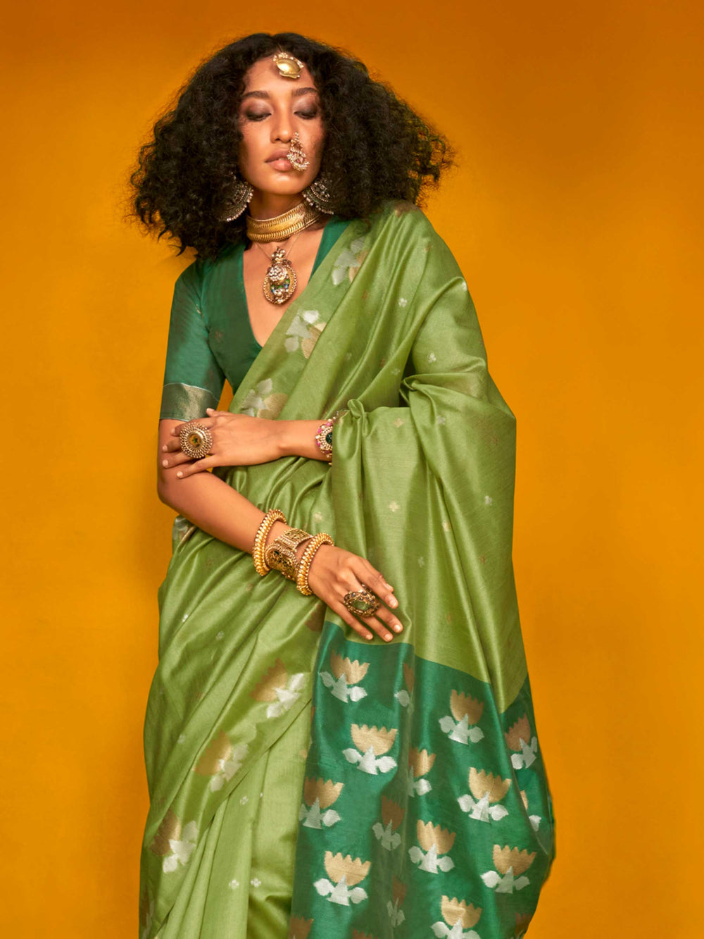 Leaf Green–Teal Green feathersoft tussar silk saree featuring woven lotus motifs and soft pallu, styled for festive rituals with a breathable finish. Leaf Green–Teal Green feathersoft tussar silk saree featuring woven lotus motifs and soft pallu, styled for festive rituals with a breathable finish..