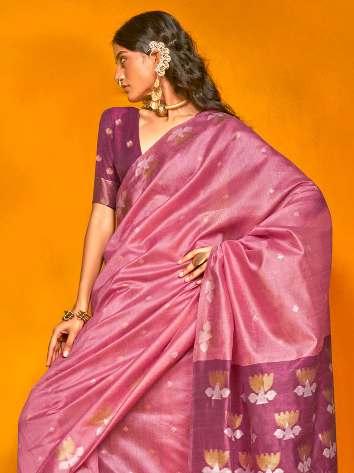 Rose Pink–Grape Purple feathersoft tussar silk saree featuring woven lotus motifs and soft pallu, styled for festive rituals with a breathable finish. Rose Pink–Grape Purple feathersoft tussar silk saree featuring woven lotus motifs and soft pallu, styled for festive rituals with a breathable finish..