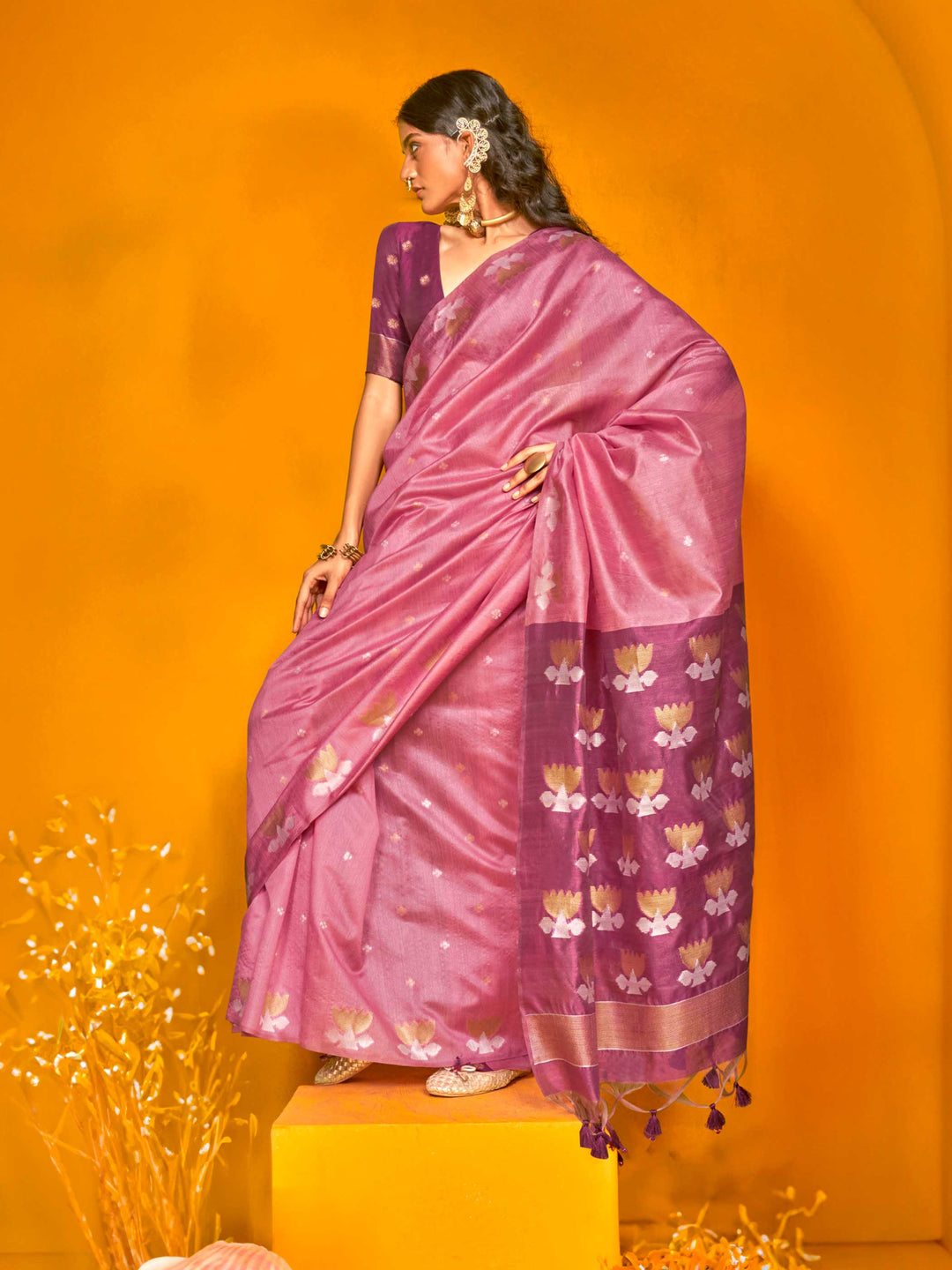 Rose Pink–Grape Purple feathersoft tussar silk saree featuring woven lotus motifs and soft pallu, styled for festive rituals with a breathable finish. Rose Pink–Grape Purple feathersoft tussar silk saree featuring woven lotus motifs and soft pallu, styled for festive rituals with a breathable finish..