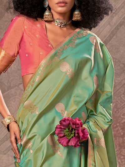 Mint Green–Rose Peach two-tone satin silk saree with woven zari work, styled for bridal wedding ceremonies with jacquard pattern and contrast pallu elegance. Mint Green–Rose Peach two-tone satin silk saree with woven zari work, styled for bridal wedding ceremonies with jacquard pattern and contrast pallu elegance..