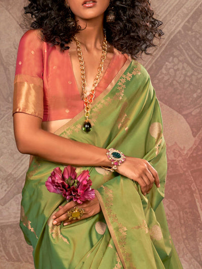 Leaf Green–Copper Peach two-tone satin silk saree with woven zari work, styled for bridal wedding ceremonies with jacquard pattern and contrast pallu elegance. Leaf Green–Copper Peach two-tone satin silk saree with woven zari work, styled for bridal wedding ceremonies with jacquard pattern and contrast pallu elegance..