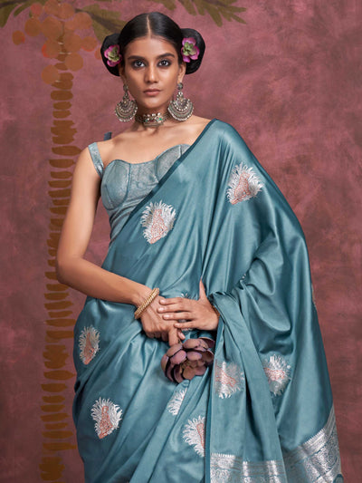 Steel Blue–Silver Blue satin silk saree with intricate jacquard zari motifs and metallic pallu, styled for wedding reception and festive bridal evenings with sculpted blouse elegance. Steel Blue–Silver Blue satin silk saree with intricate jacquard zari motifs and metallic pallu, styled for wedding reception and festive bridal evenings with sculpted blouse elegance..