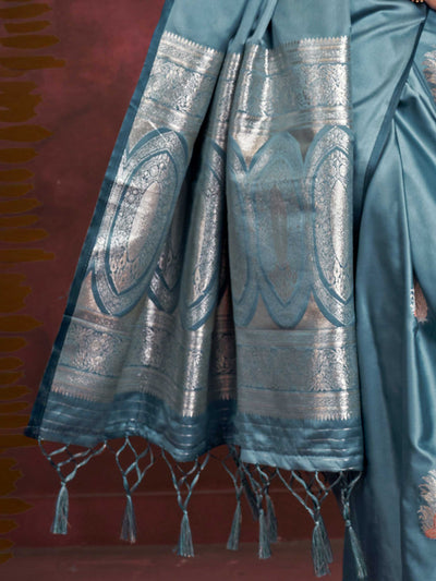 Steel Blue–Silver Blue satin silk saree with intricate jacquard zari motifs and metallic pallu, styled for wedding reception and festive bridal evenings with sculpted blouse elegance. Steel Blue–Silver Blue satin silk saree with intricate jacquard zari motifs and metallic pallu, styled for wedding reception and festive bridal evenings with sculpted blouse elegance..