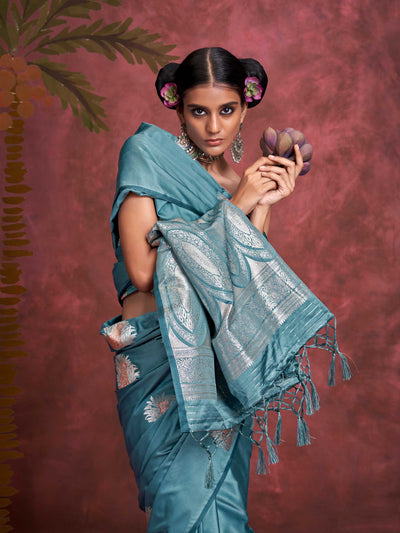 Steel Blue–Silver Blue satin silk saree with intricate jacquard zari motifs and metallic pallu, styled for wedding reception and festive bridal evenings with sculpted blouse elegance.