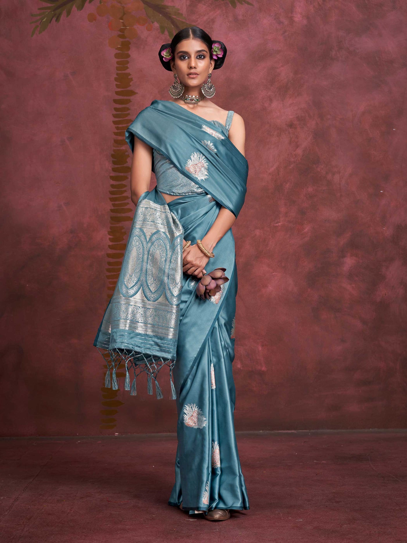 Steel Blue–Silver Blue satin silk saree with intricate jacquard zari motifs and metallic pallu, styled for wedding reception and festive bridal evenings with sculpted blouse elegance.