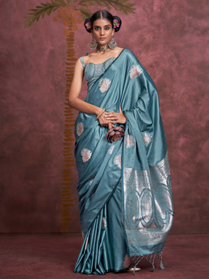 Steel Blue–Silver Blue satin silk saree with intricate jacquard zari motifs and metallic pallu, styled for wedding reception and festive bridal evenings with sculpted blouse elegance. Steel Blue–Silver Blue satin silk saree with intricate jacquard zari motifs and metallic pallu, styled for wedding reception and festive bridal evenings with sculpted blouse elegance..