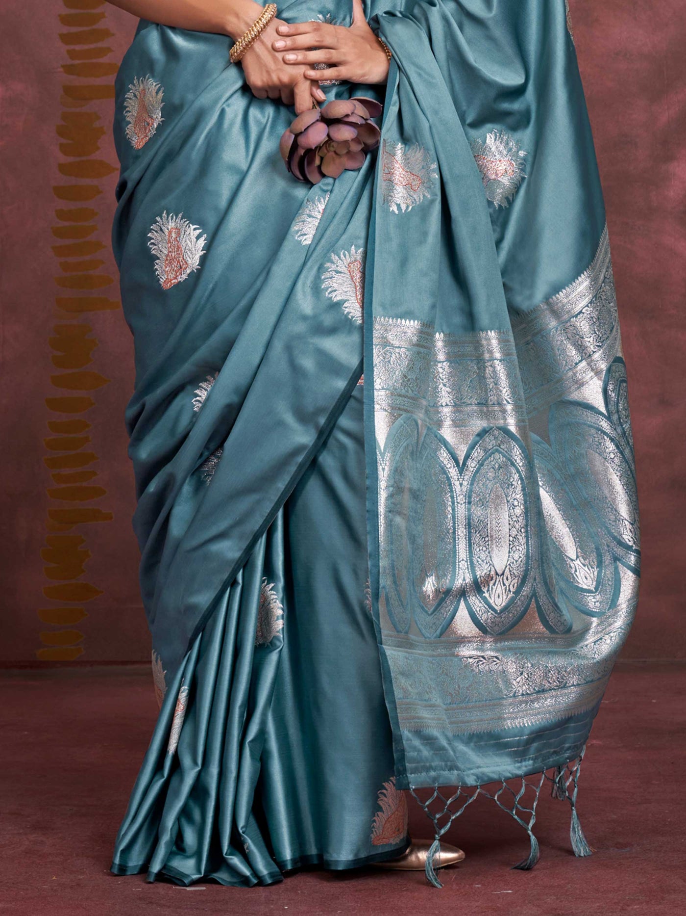 Steel Blue–Silver Blue satin silk saree with intricate jacquard zari motifs and metallic pallu, styled for wedding reception and festive bridal evenings with sculpted blouse elegance. Steel Blue–Silver Blue satin silk saree with intricate jacquard zari motifs and metallic pallu, styled for wedding reception and festive bridal evenings with sculpted blouse elegance..