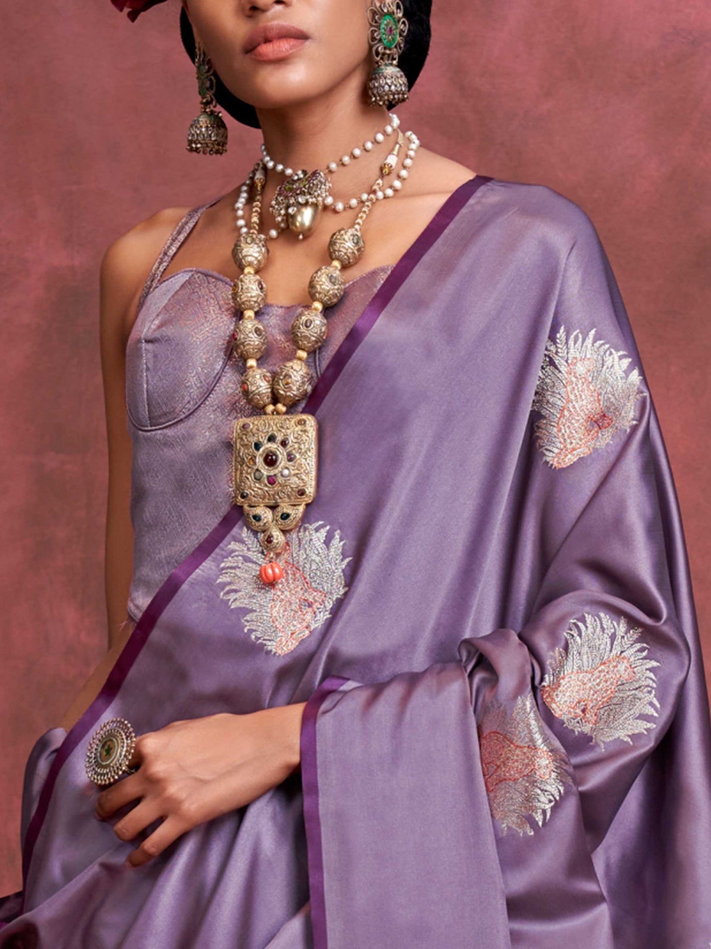 Plum Lavender–Lilac Silver satin silk saree with intricate jacquard zari motifs and metallic pallu, styled for wedding reception and festive bridal evenings with sculpted blouse elegance. Plum Lavender–Lilac Silver satin silk saree with intricate jacquard zari motifs and metallic pallu, styled for wedding reception and festive bridal evenings with sculpted blouse elegance..