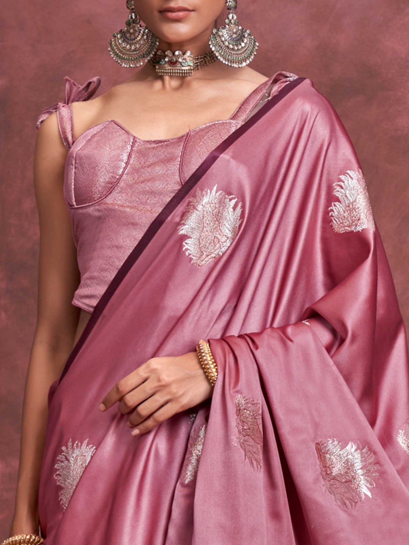 Blush Rose–Silver Mauve satin silk saree with intricate jacquard zari motifs and metallic pallu, styled for wedding reception and festive bridal evenings with sculpted blouse elegance. Blush Rose–Silver Mauve satin silk saree with intricate jacquard zari motifs and metallic pallu, styled for wedding reception and festive bridal evenings with sculpted blouse elegance..
