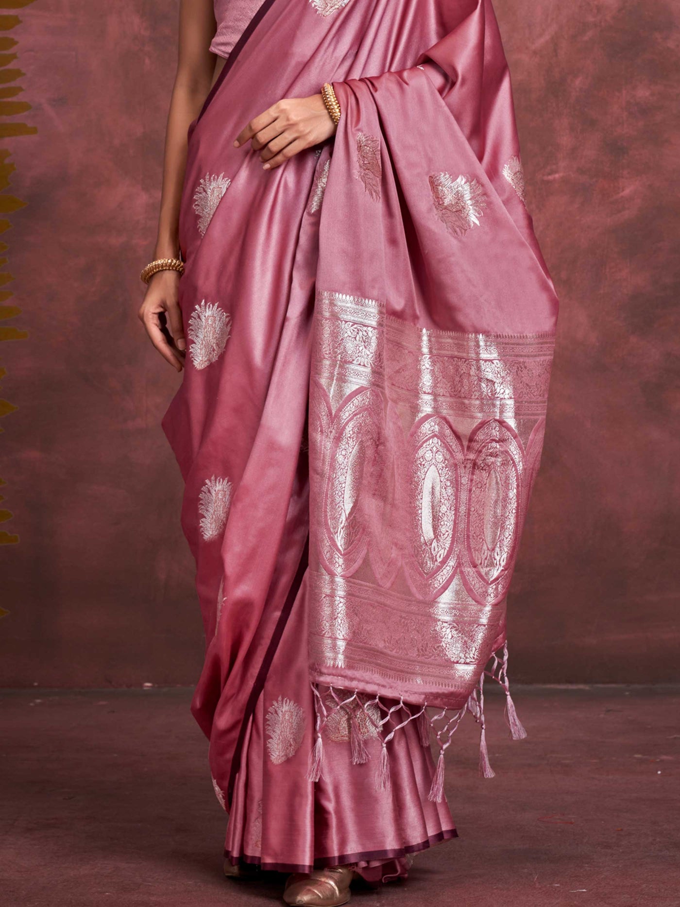 Blush Rose–Silver Mauve satin silk saree with intricate jacquard zari motifs and metallic pallu, styled for wedding reception and festive bridal evenings with sculpted blouse elegance. Blush Rose–Silver Mauve satin silk saree with intricate jacquard zari motifs and metallic pallu, styled for wedding reception and festive bridal evenings with sculpted blouse elegance..