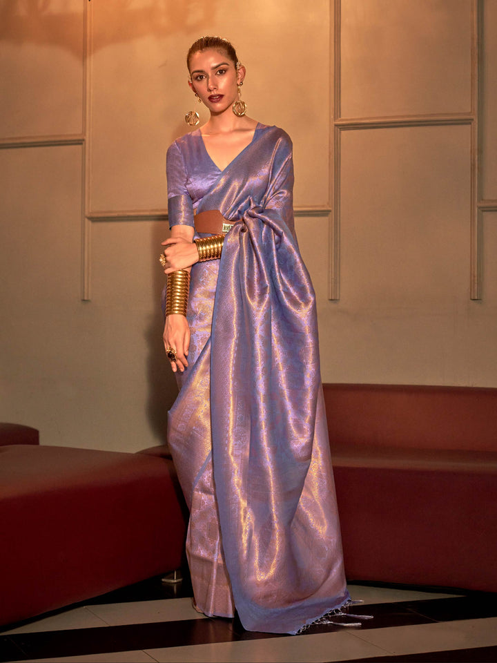 Lavender lilac kanjivaram silk saree featuring silver zari weave and fluid jacquard pallu. Dual-tone lavender silk saree with lilac undertones and woven silver motifs for bridal elegance.