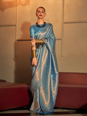 Icy Blue–Silver kanjivaram silk saree with subtle dual-tone effect and intricate zari border. Icy Blue–Silver wedding saree crafted from pastel silk and jacquard floral weaving.