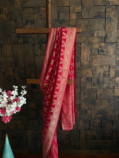 Cherry red ethnic saree with soft drape and elegant zari finish