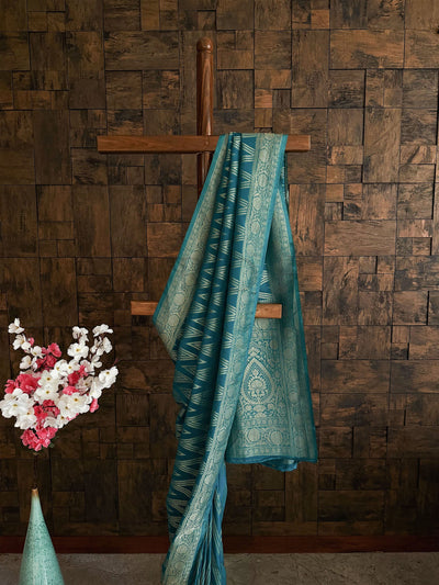 Elegant teal saree for sangeet with soft flow and gold border