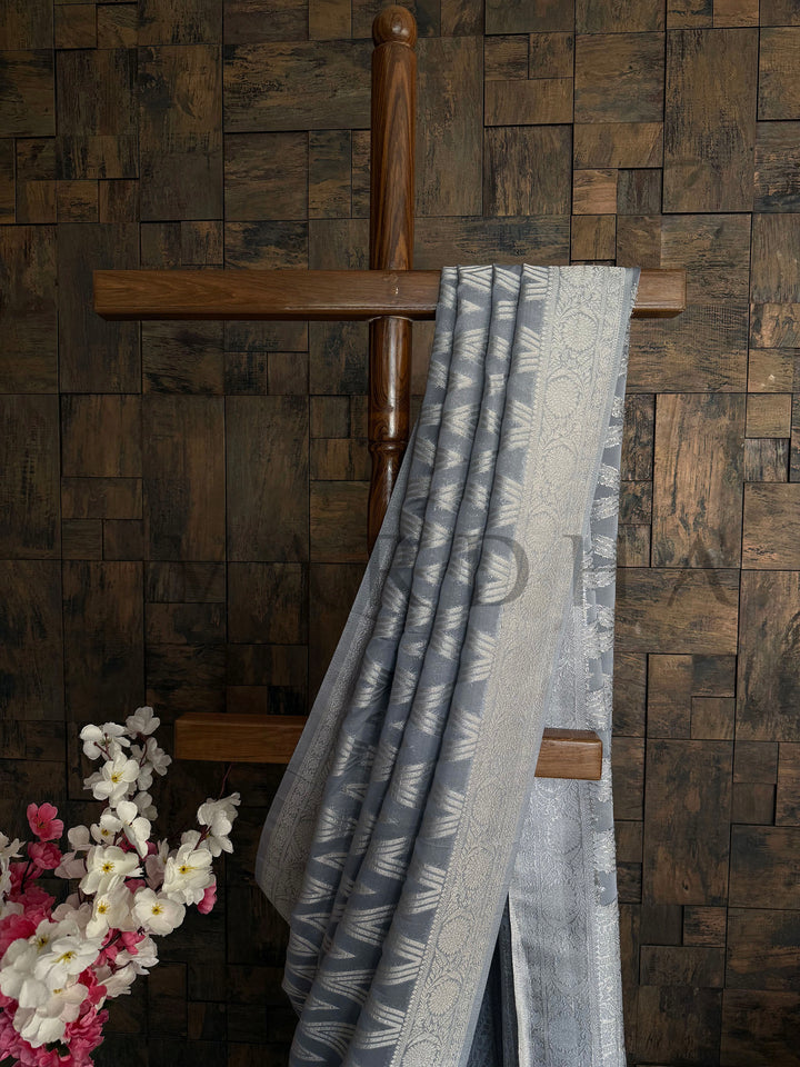 Close-up view of delicate thread work on gray georgette fabric