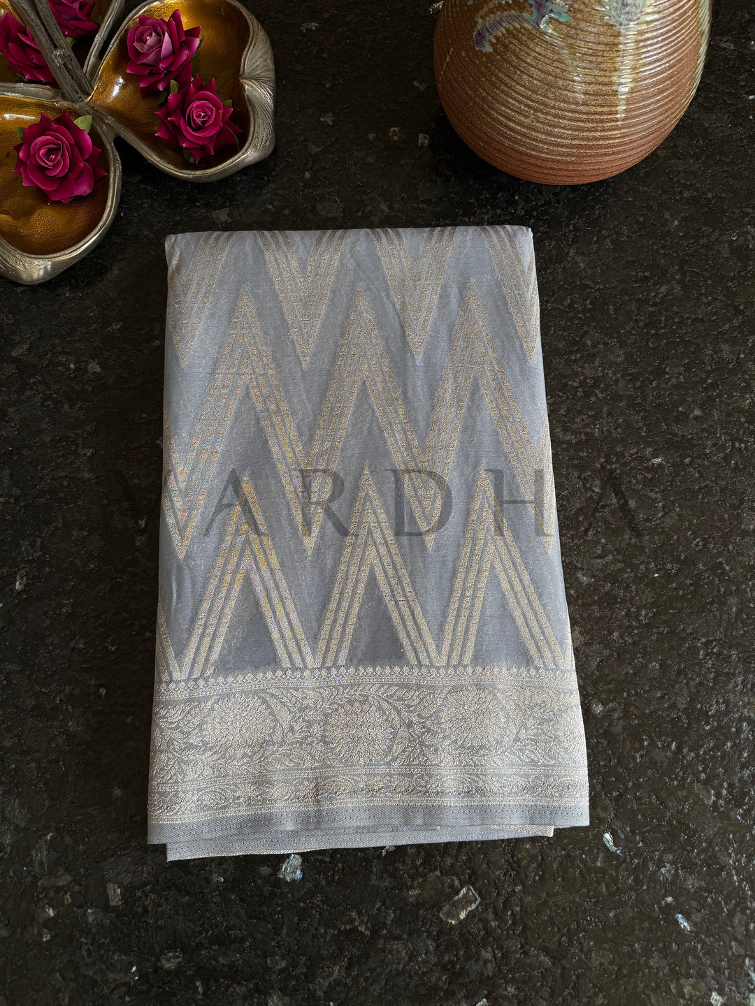 Elegant gray saree with delicate embellishments at the edges