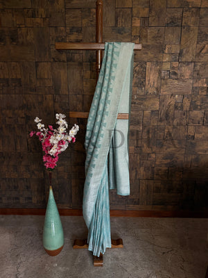 Full view of turquoise saree styled with fluid drape