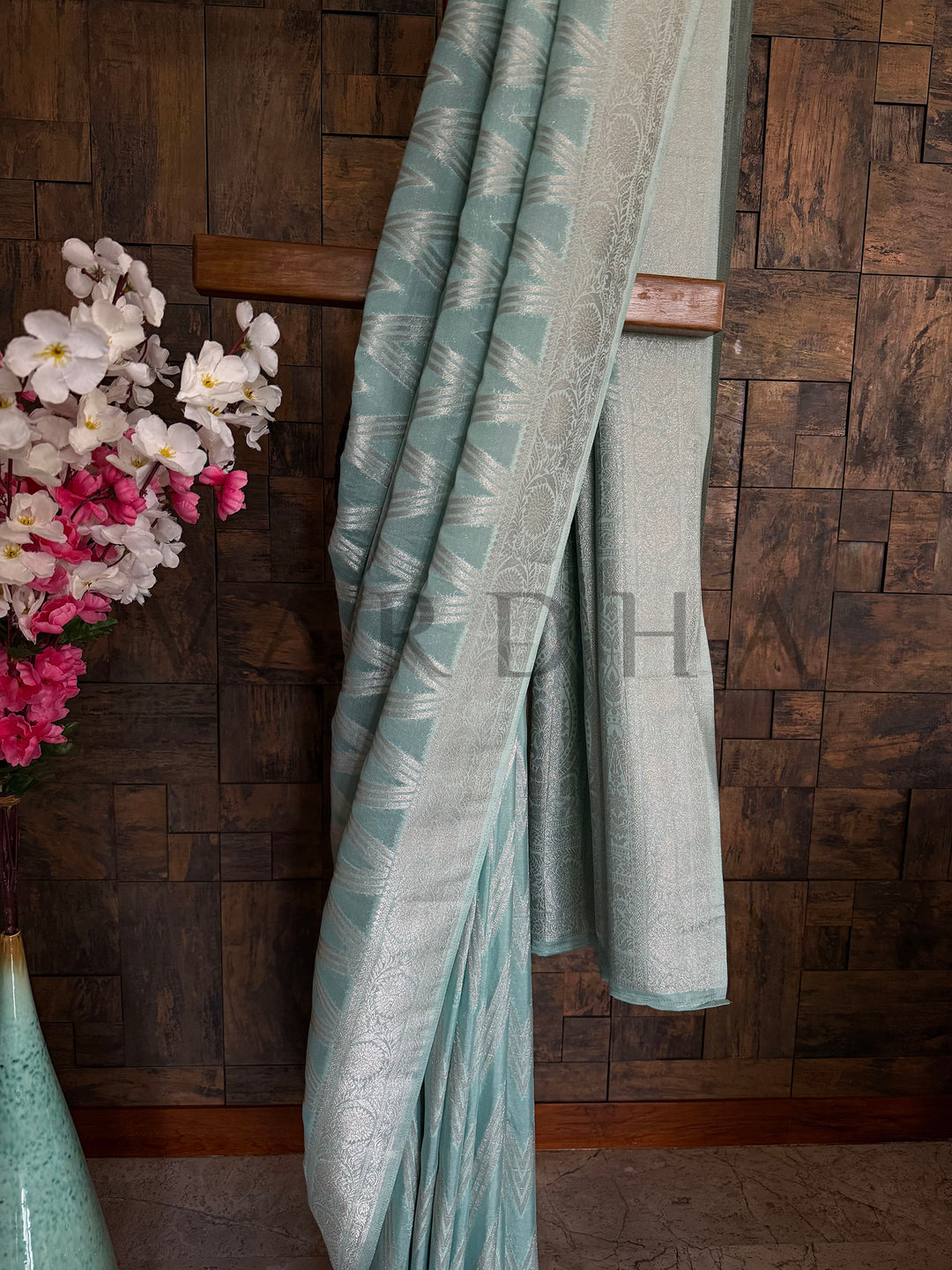 Vibrant turquoise saree with a soft, crinkled fabric texture