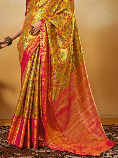 Yellow–Pink Banarasi satin silk saree with zari work and woven parrot motifs, styled for traditional Indian wedding rituals with luxury finish. Yellow–Pink Banarasi satin silk saree with zari work and woven parrot motifs, styled for traditional Indian wedding rituals with luxury finish..
