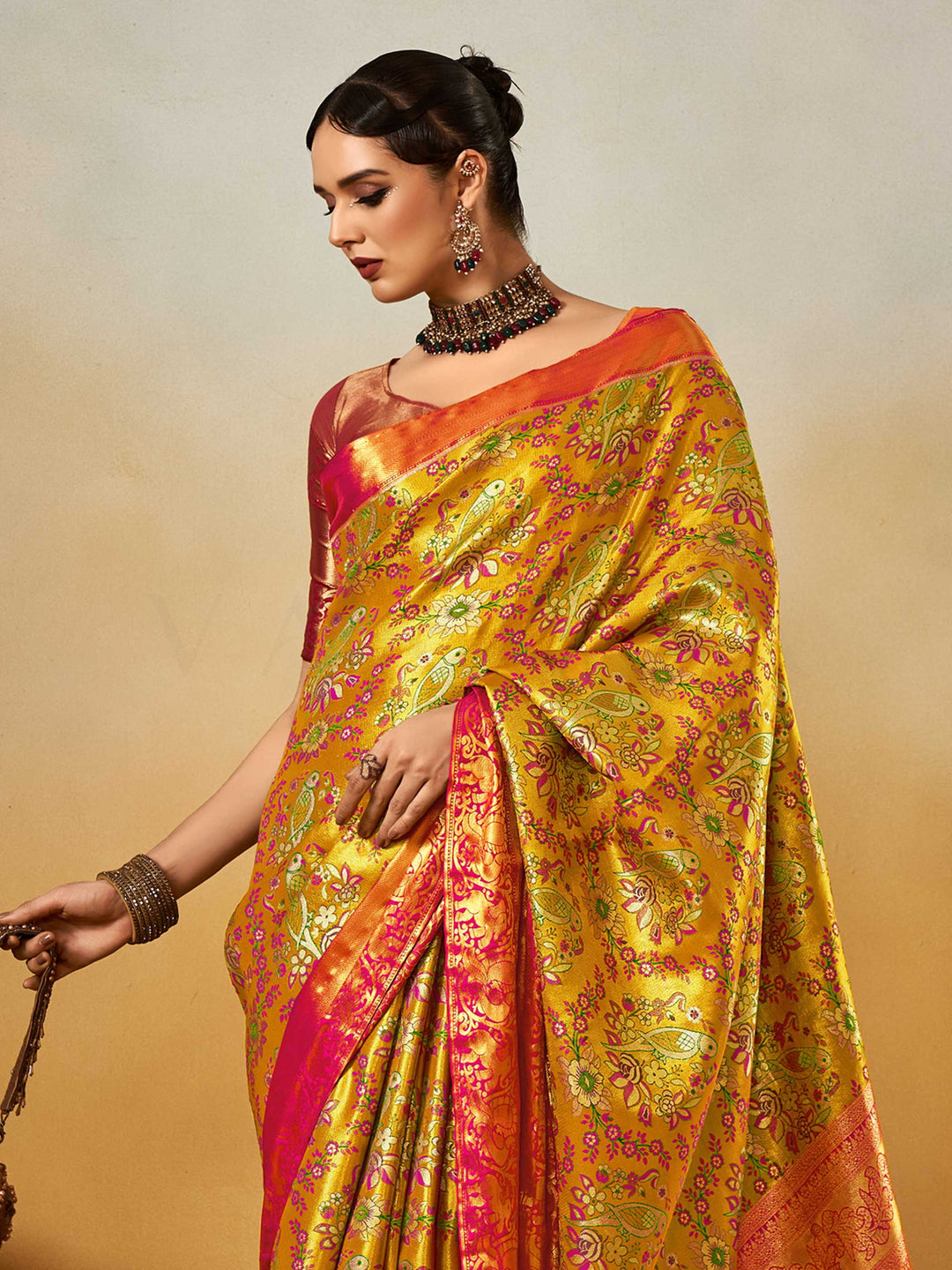 Yellow–Pink Banarasi satin silk saree with zari work and woven parrot motifs, styled for traditional Indian wedding rituals with luxury finish. Yellow–Pink Banarasi satin silk saree with zari work and woven parrot motifs, styled for traditional Indian wedding rituals with luxury finish..