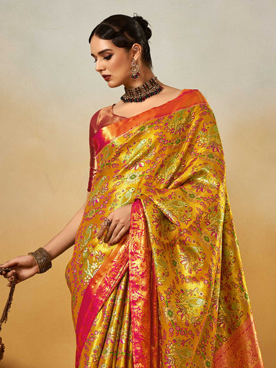 Yellow–Pink Banarasi satin silk saree with zari work and woven parrot motifs, styled for traditional Indian wedding rituals with luxury finish. Yellow–Pink Banarasi satin silk saree with zari work and woven parrot motifs, styled for traditional Indian wedding rituals with luxury finish..