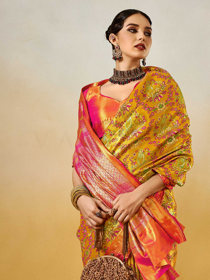 Yellow–Pink Banarasi satin silk saree with zari work and woven parrot motifs, styled for traditional Indian wedding rituals with luxury finish. Yellow–Pink Banarasi satin silk saree with zari work and woven parrot motifs, styled for traditional Indian wedding rituals with luxury finish..