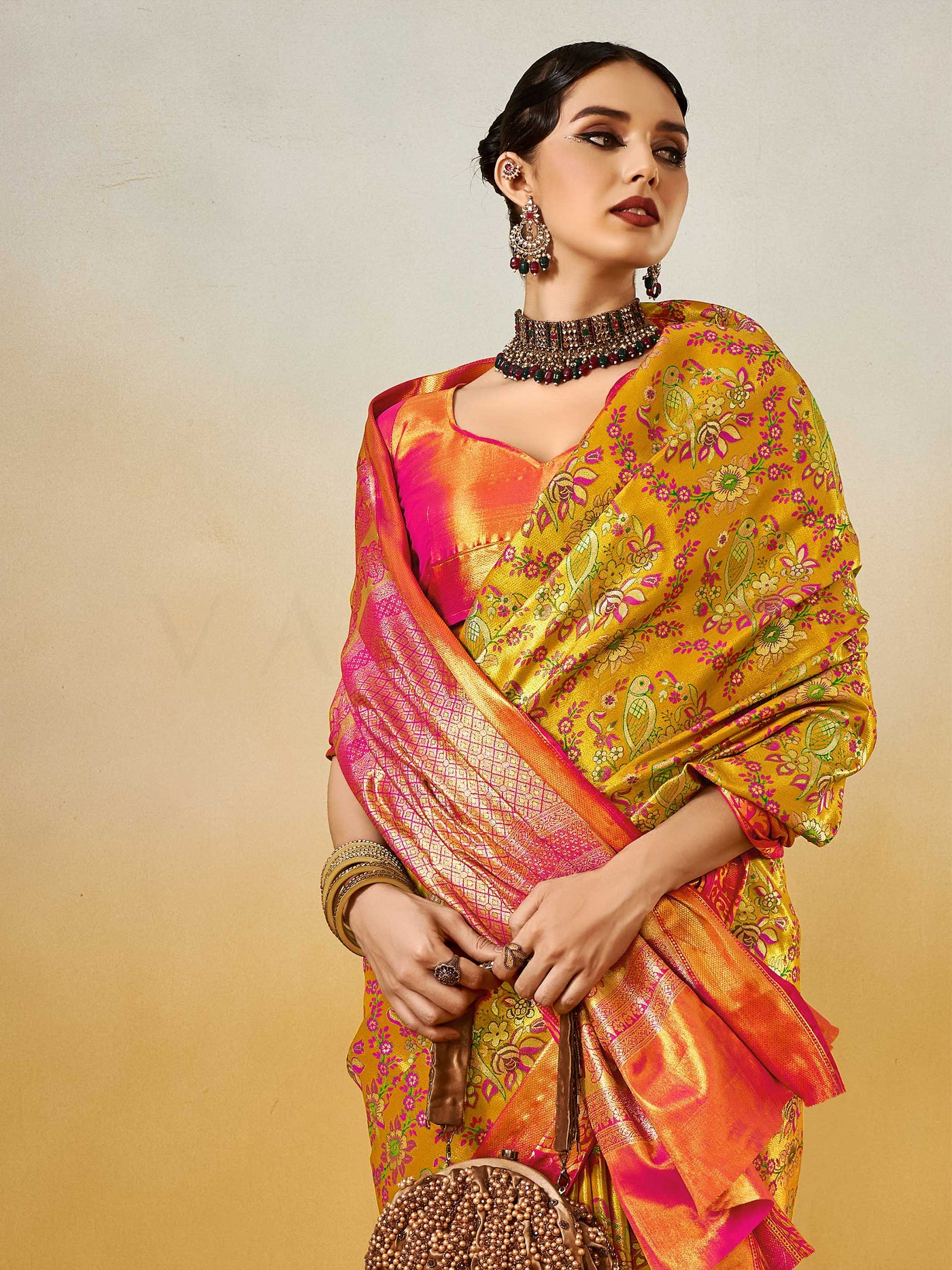 Yellow–Pink Banarasi satin silk saree with zari work and woven parrot motifs, styled for traditional Indian wedding rituals with luxury finish. Yellow–Pink Banarasi satin silk saree with zari work and woven parrot motifs, styled for traditional Indian wedding rituals with luxury finish..